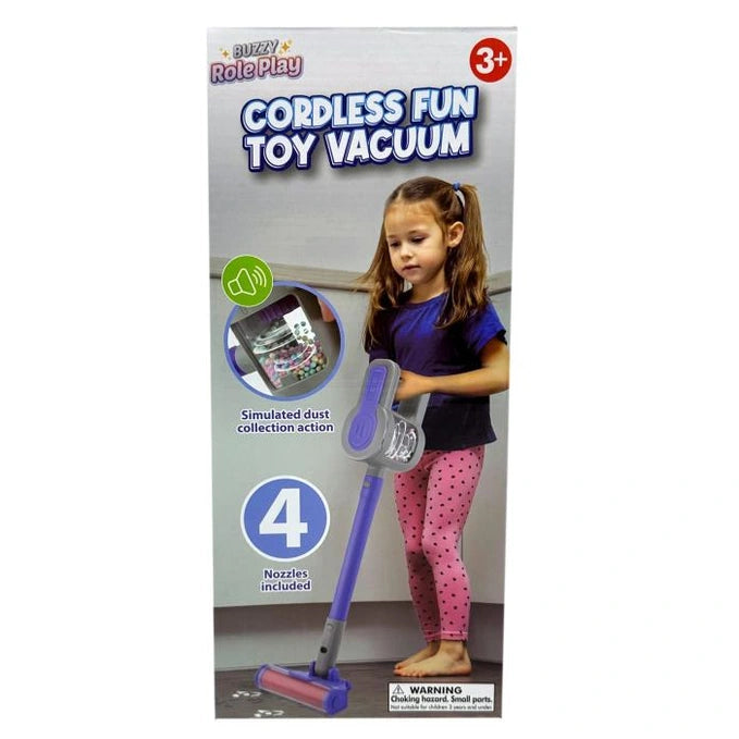 A girl in a blue shirt and pink polka dot leggings playing with a purple toy vacuum cleaner.